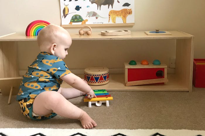 Child playing with a colorful toy on the floor