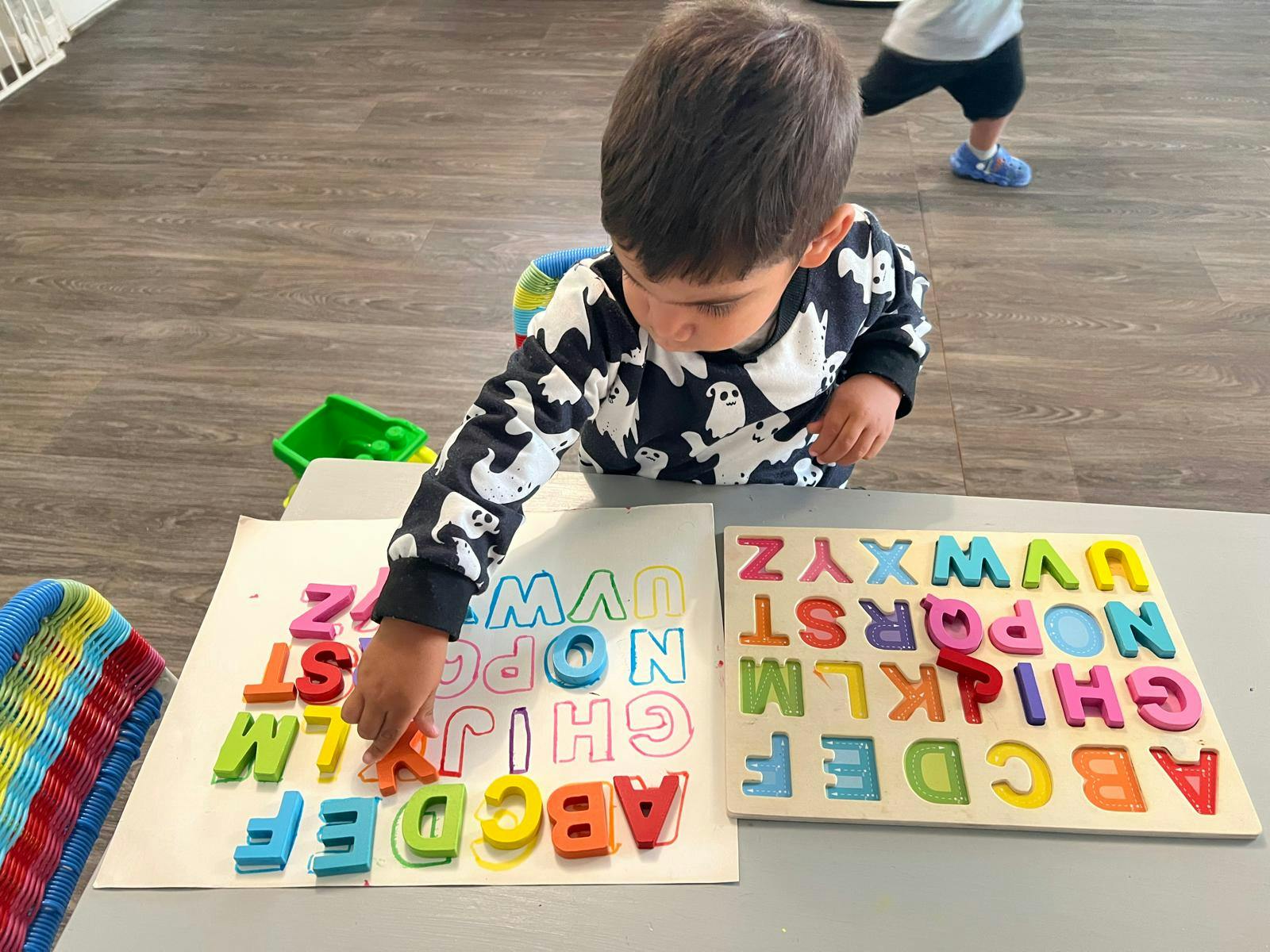 Child playing with colorful alphabet letter puzzles