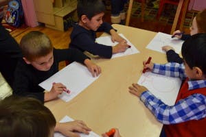 Children drawing at a table