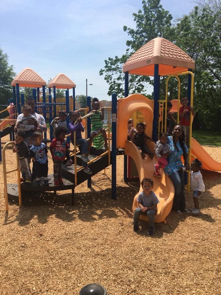 People and children on a playground structure