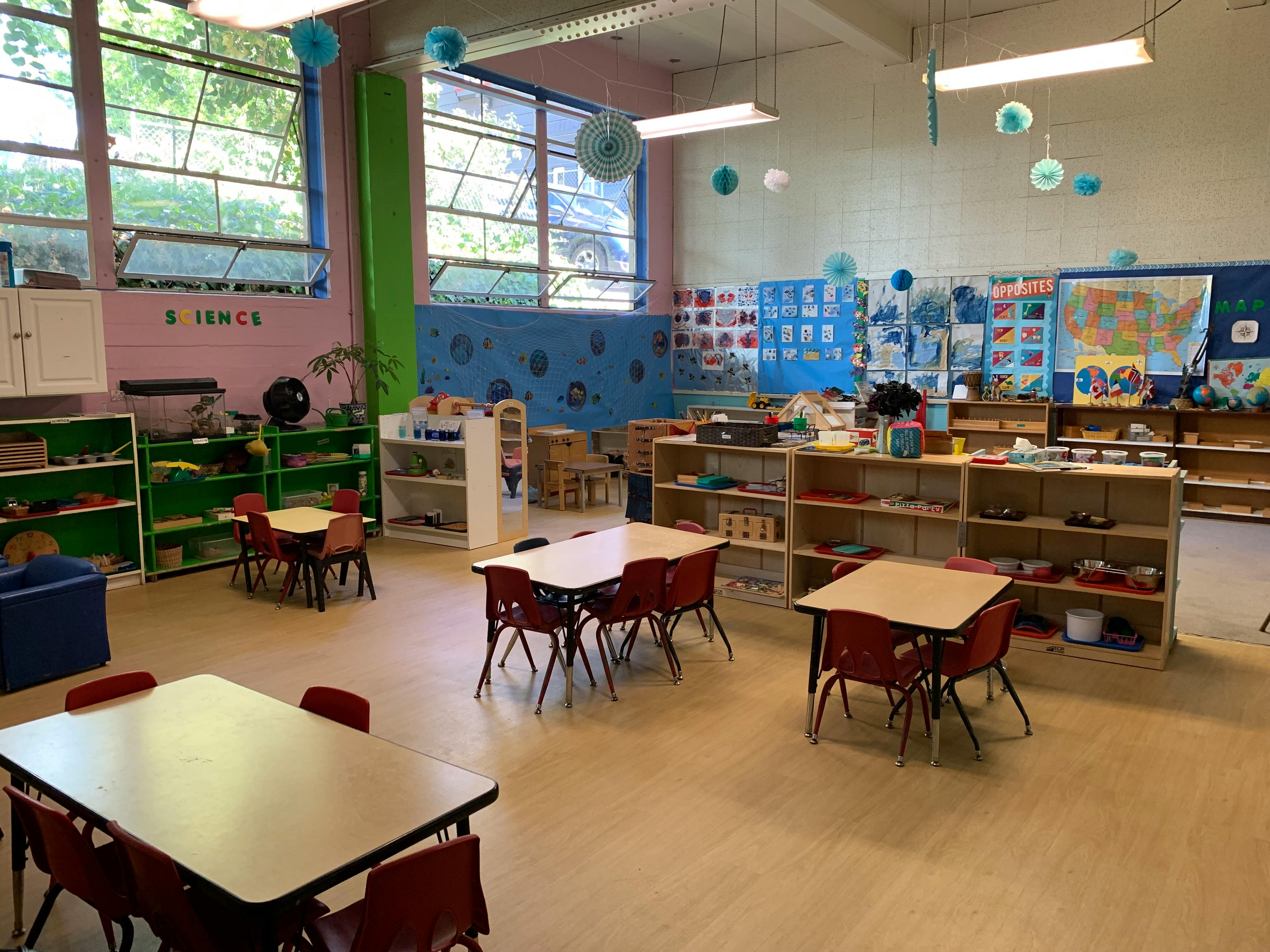 Empty classroom with small tables and chairs