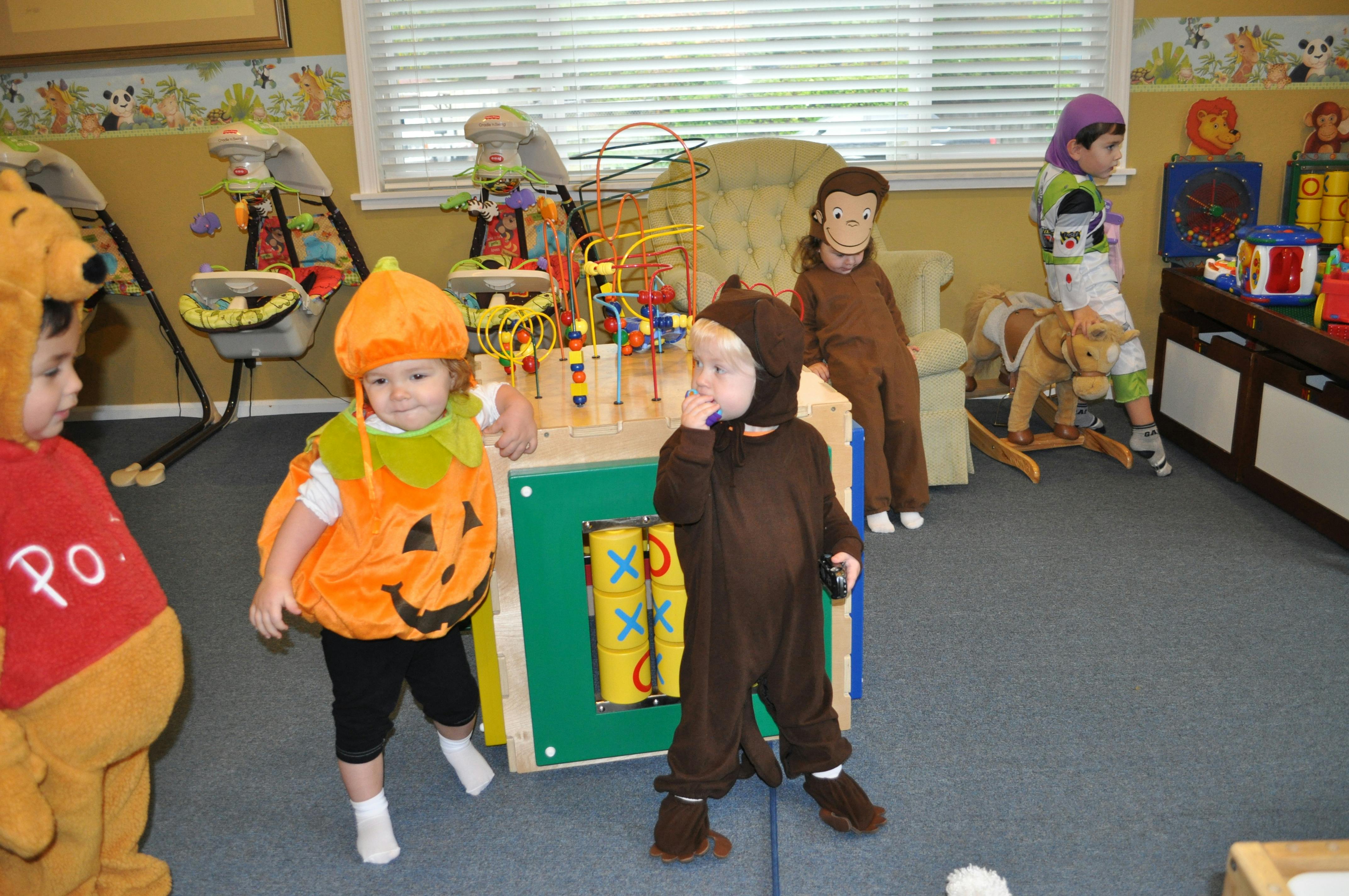 Children in costumes playing in a room