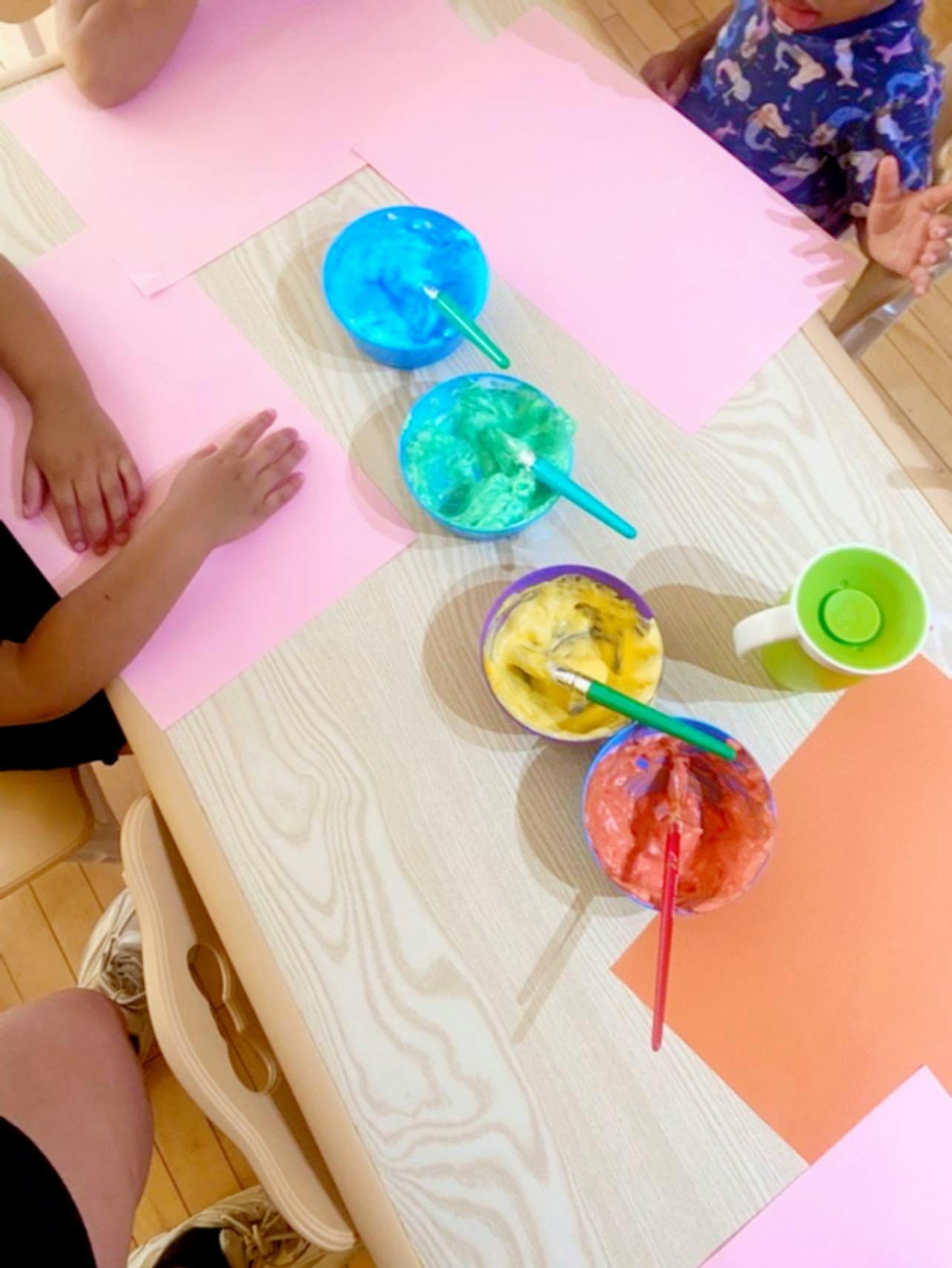 Children at a table with paint and paper