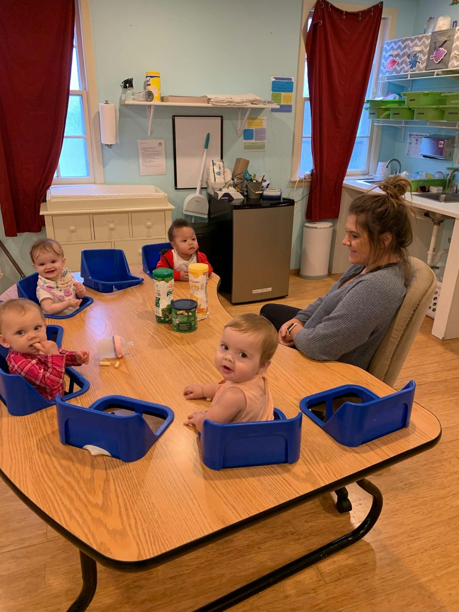 Adult and multiple children sitting at a table