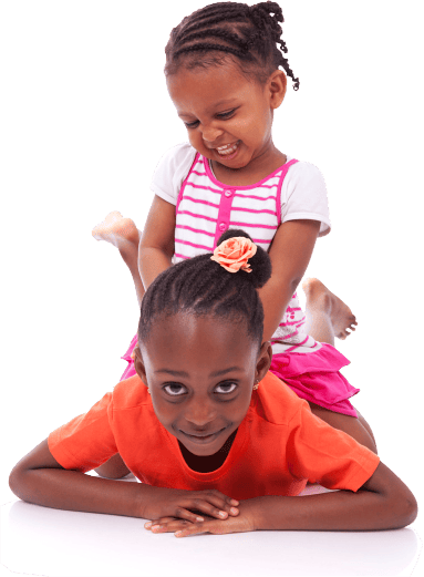 Child lying on stomach with another child on their back