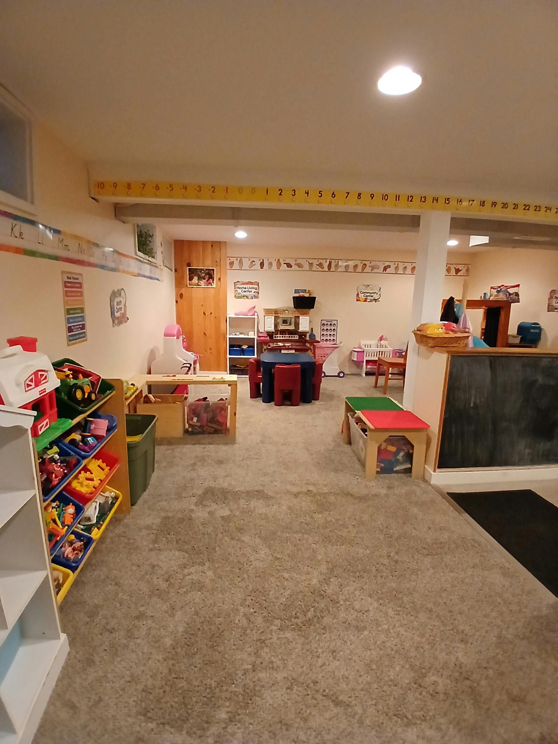 Playroom with small tables, chairs, and toy storage