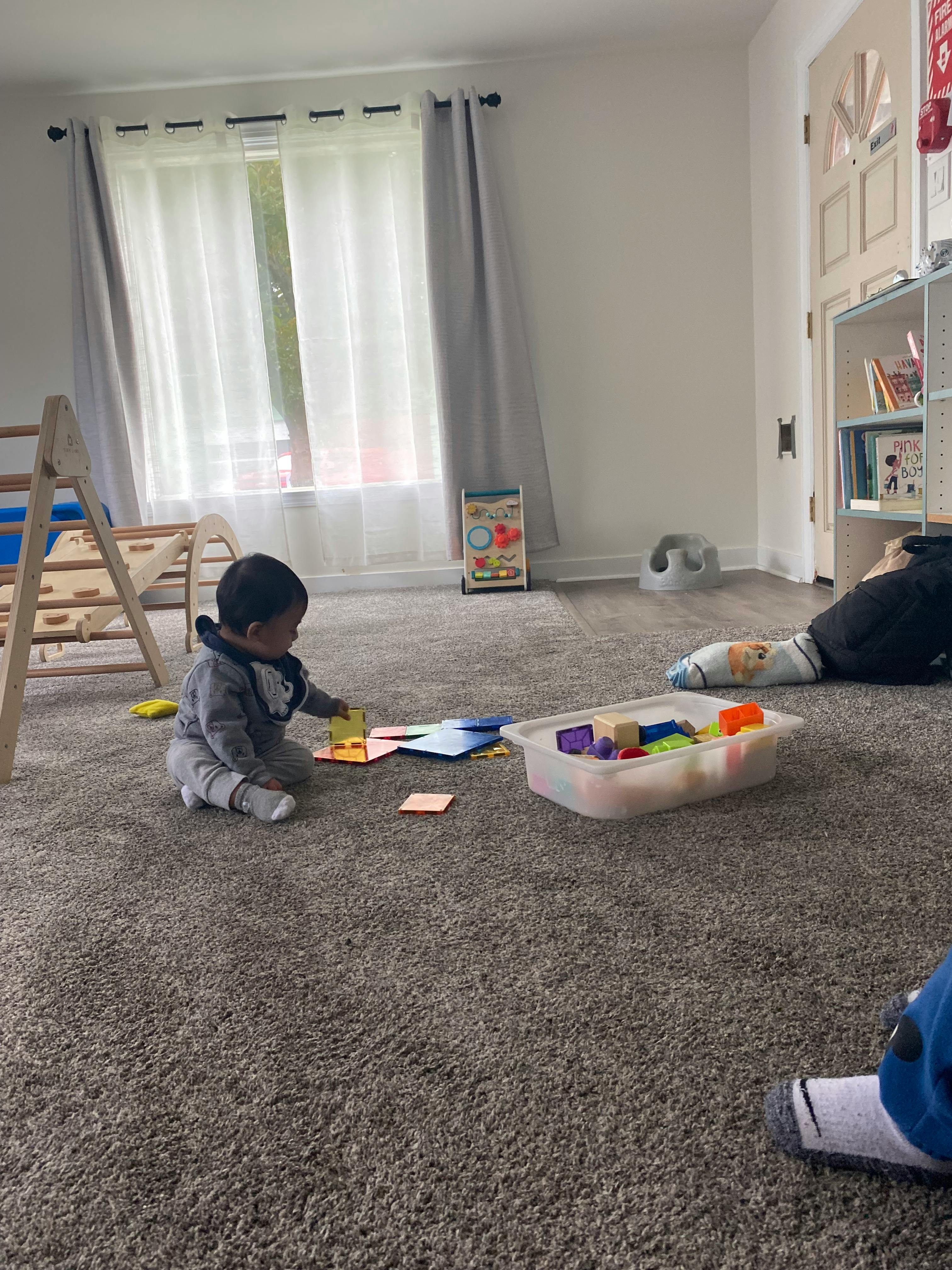 Child playing with blocks on a carpeted floor