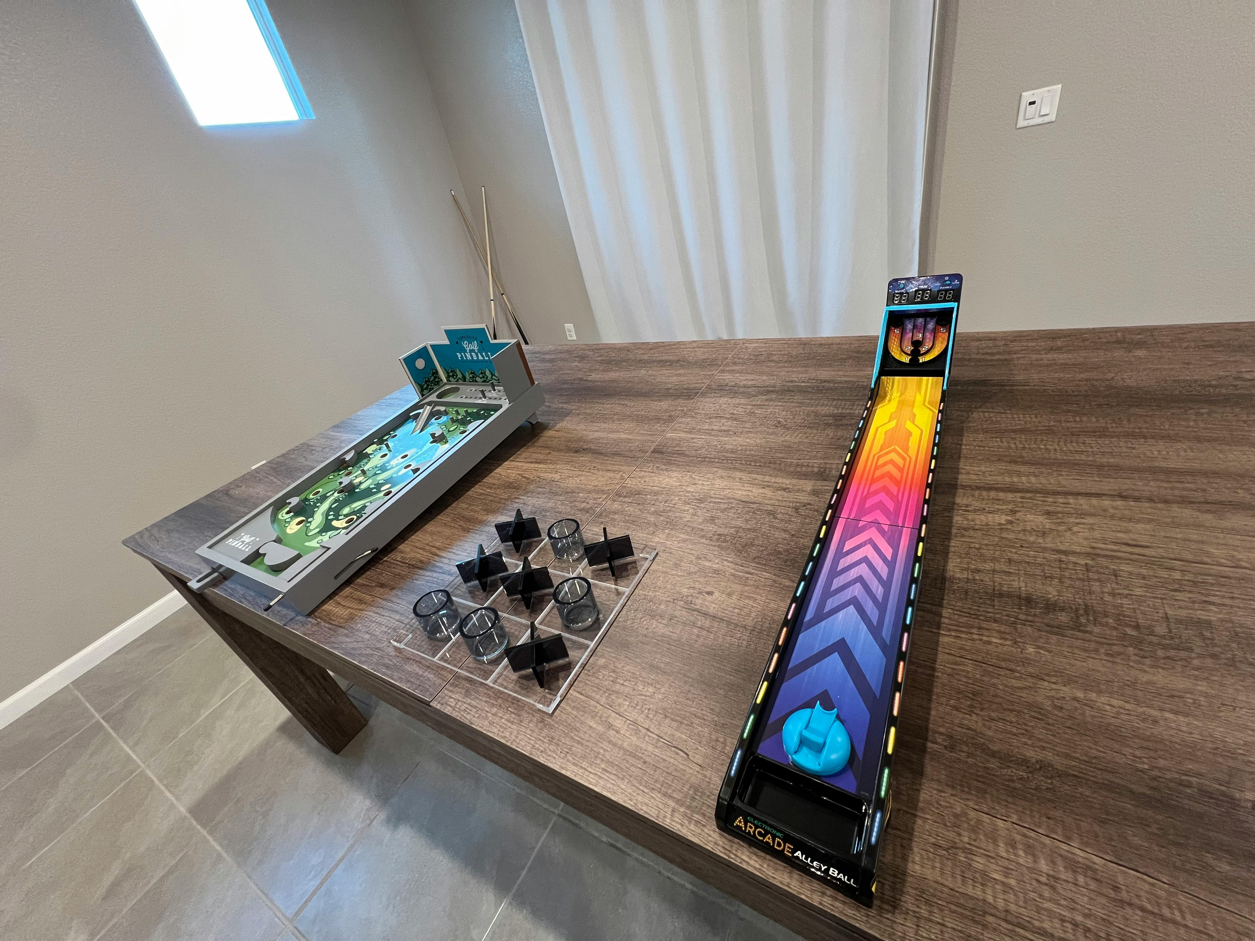 Tabletop games including a mini golf game and a rainbow-colored skee-ball game