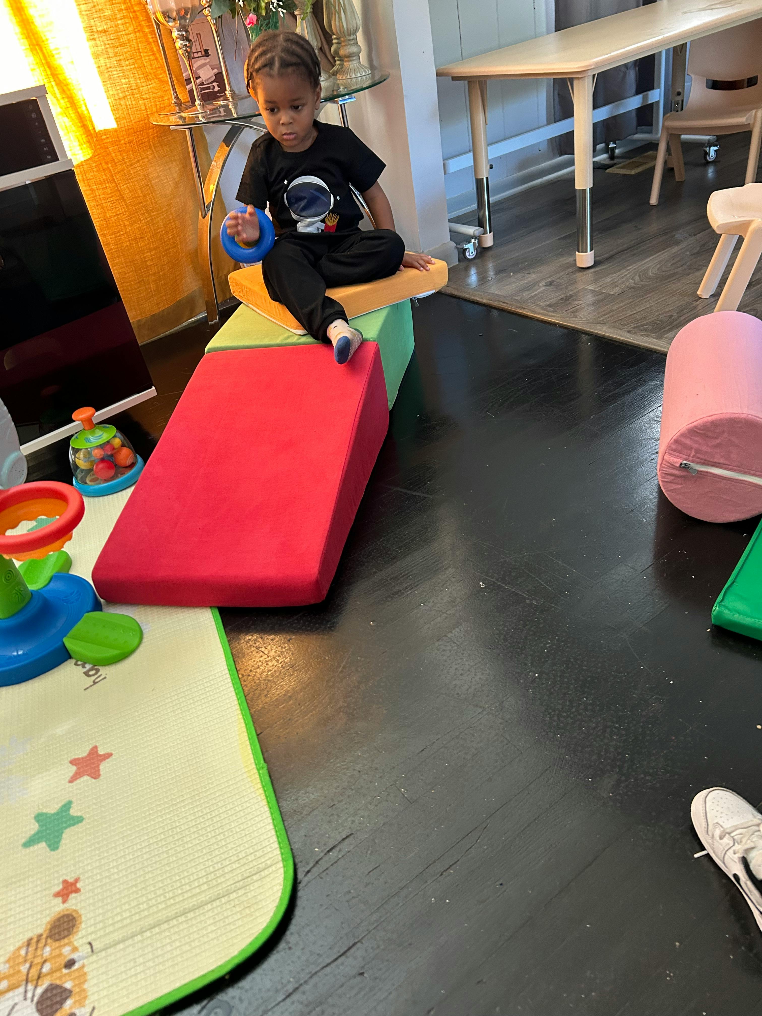 Child sitting on soft play equipment