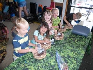 Children making crafts at a table
