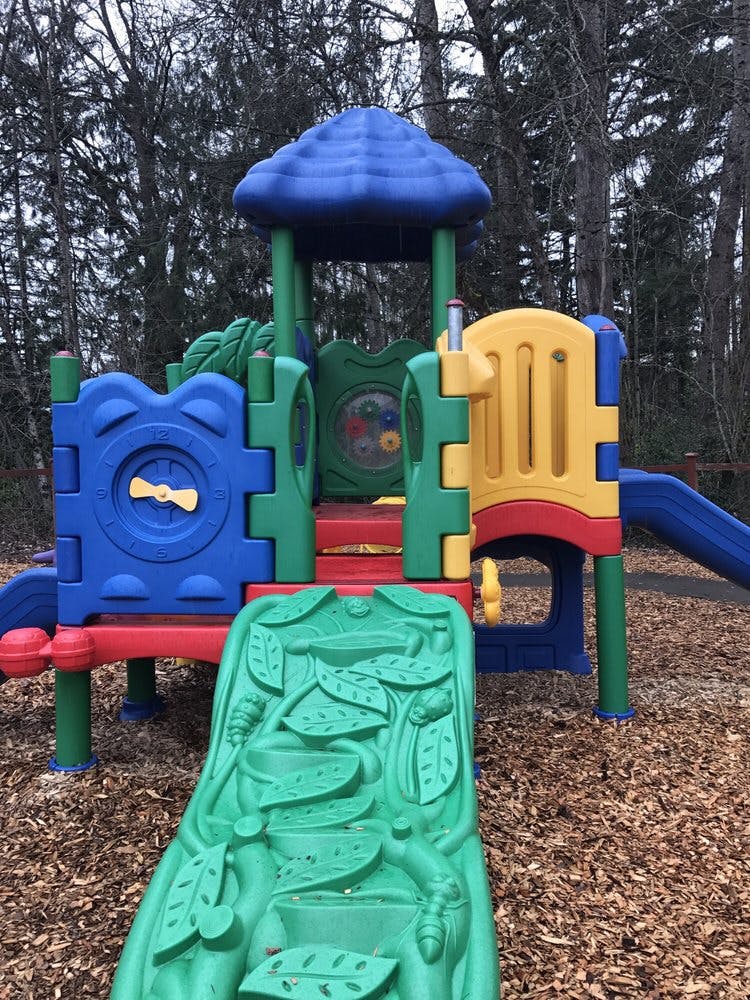 Colorful playground structure with slides and climbing elements