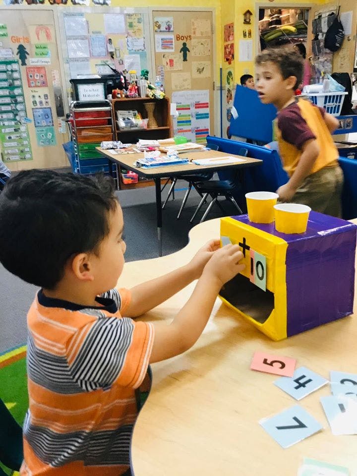 Child playing with a math game in a classroom