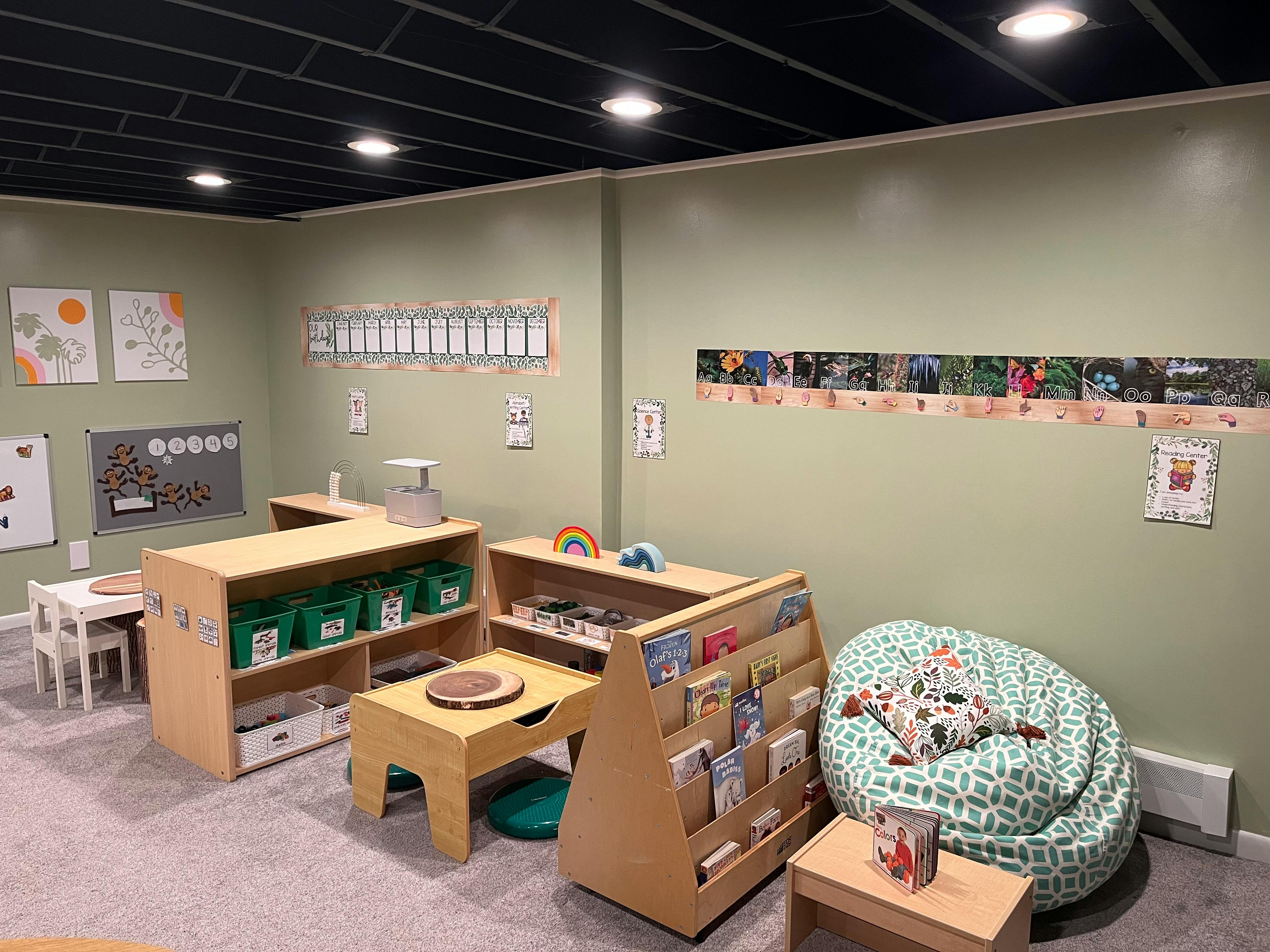 Classroom with small tables, shelves, and a beanbag chair