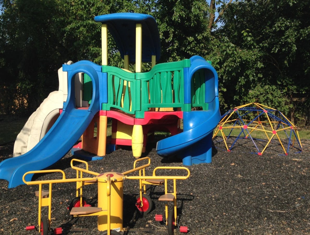 Playground with slides, climbing structure, and merry-go-round