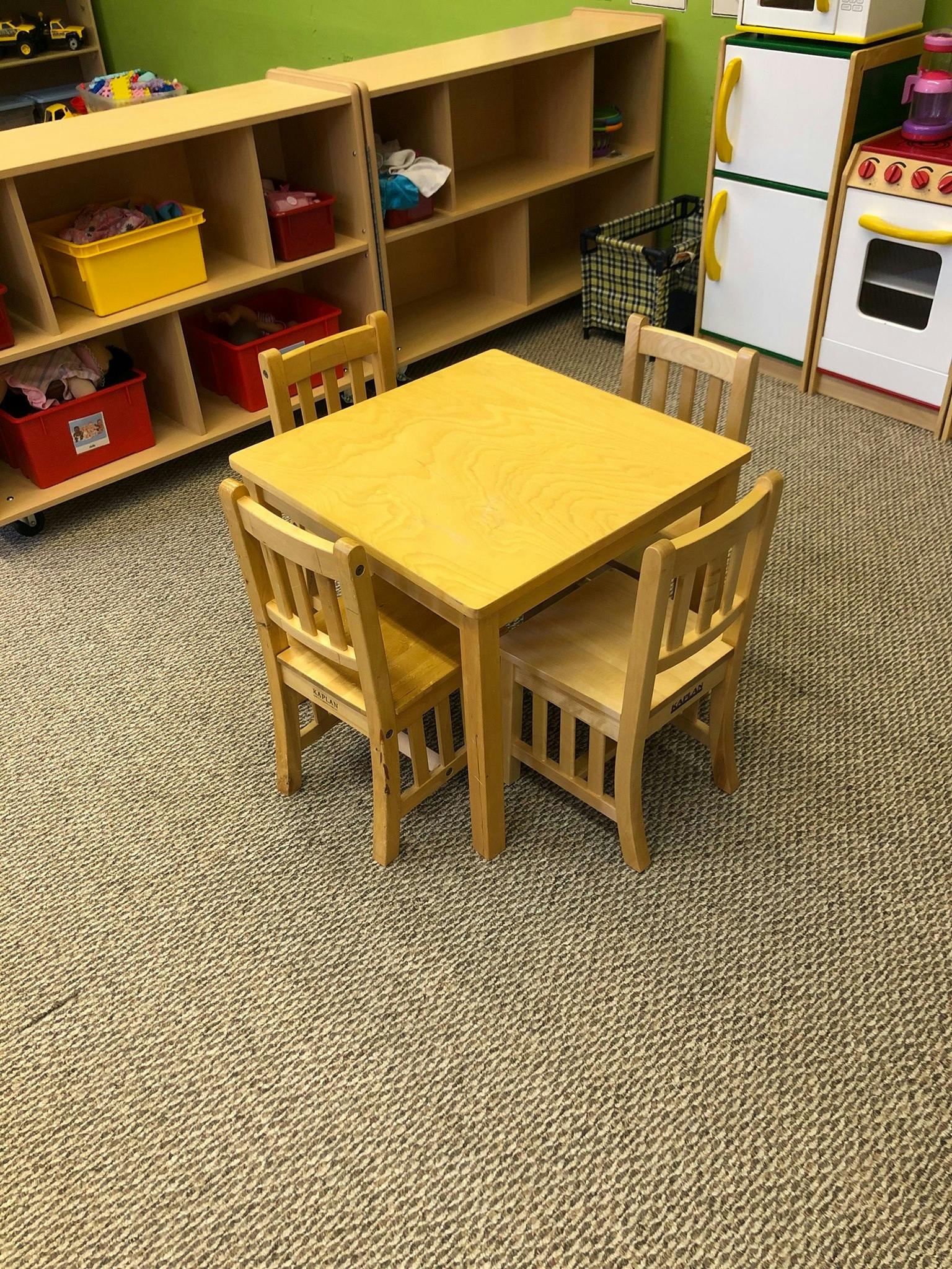 Small wooden table with four chairs in a classroom
