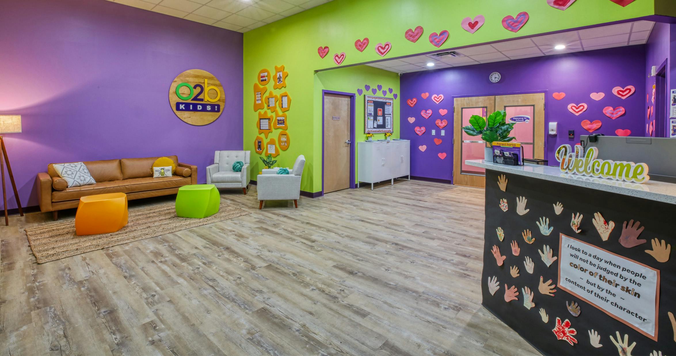 Lobby area of a child care facility with O2B Kids! branding