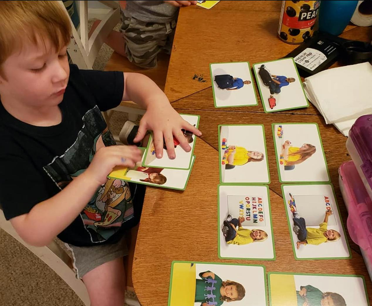 Child playing with picture cards at a table