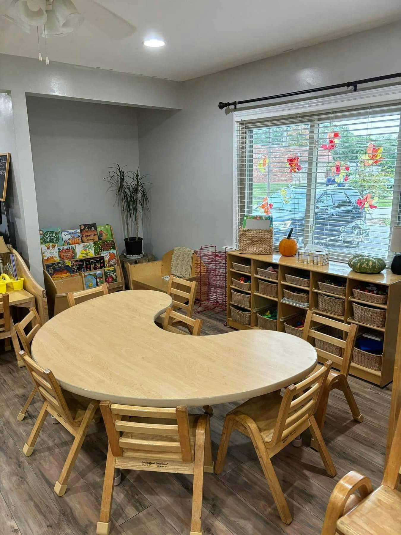 Classroom with a crescent-shaped table and small chairs