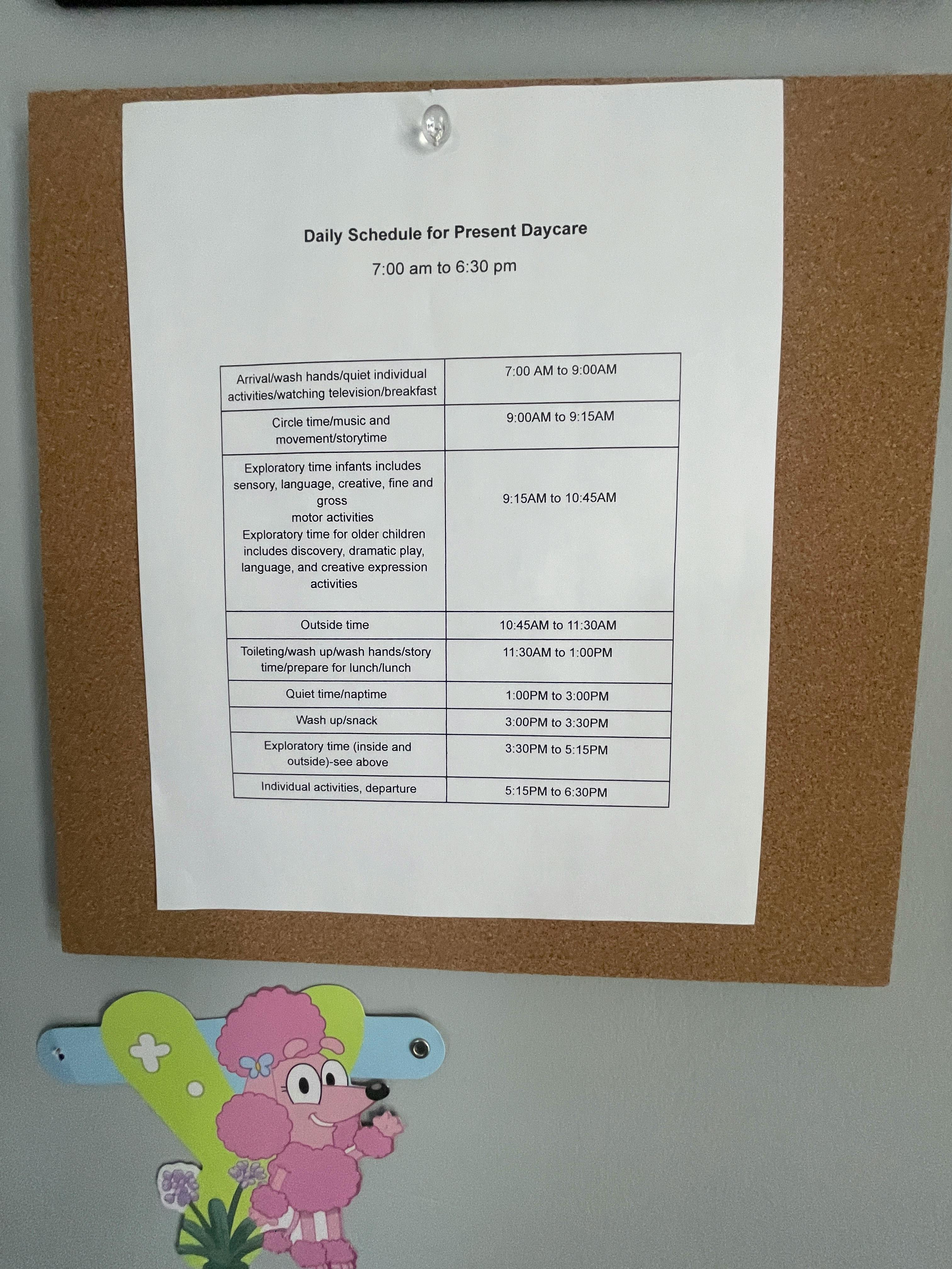 Daily Schedule for Present Daycare sign on a cork board