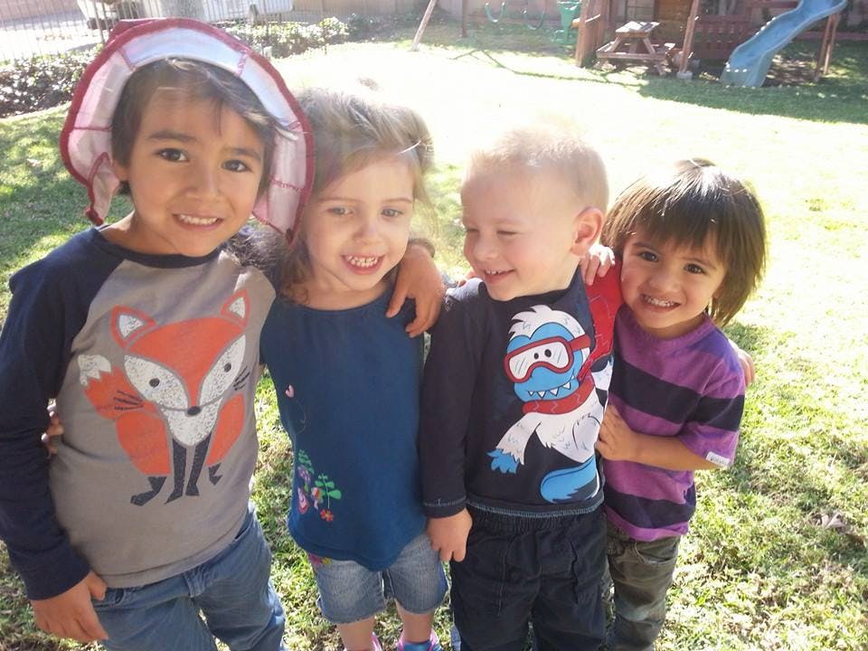 Four children standing together outdoors