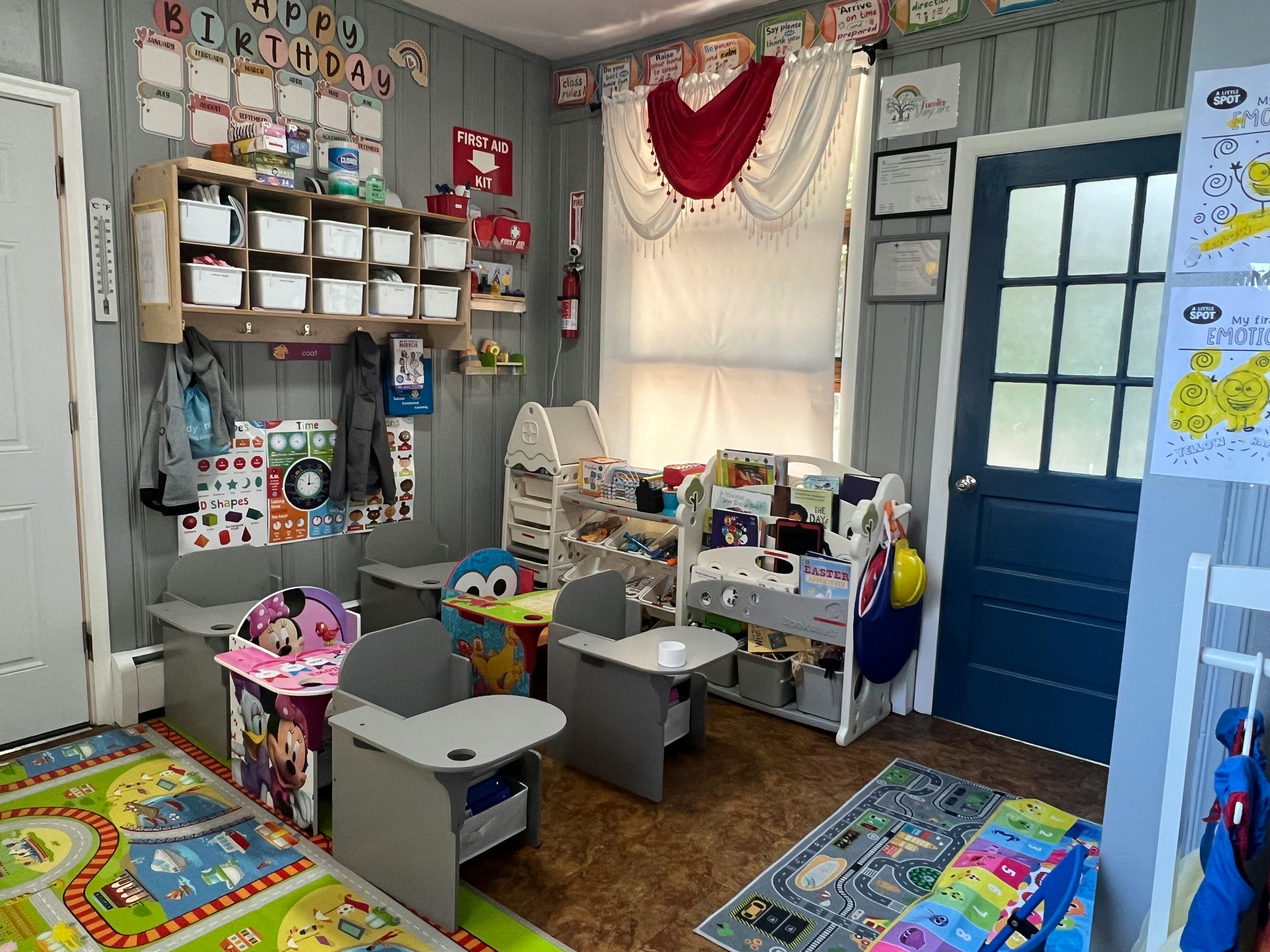 A classroom with small desks, chairs, and storage shelves