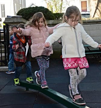 Children balancing on a beam