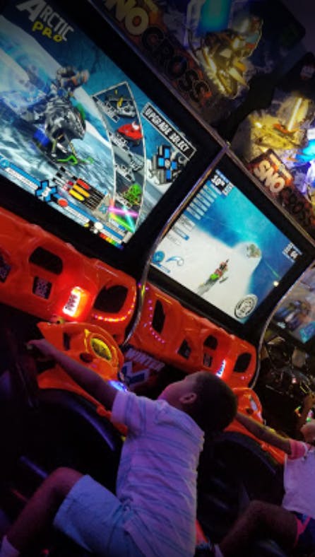 Child playing an arcade racing game