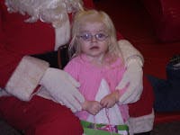 Child wearing glasses sitting on a person's lap