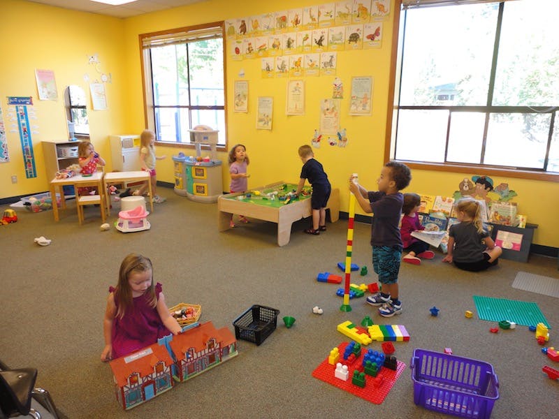 Children playing with toys in a classroom