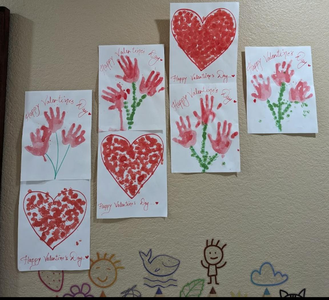 Multiple handmade cards with red hearts and handprint flowers
