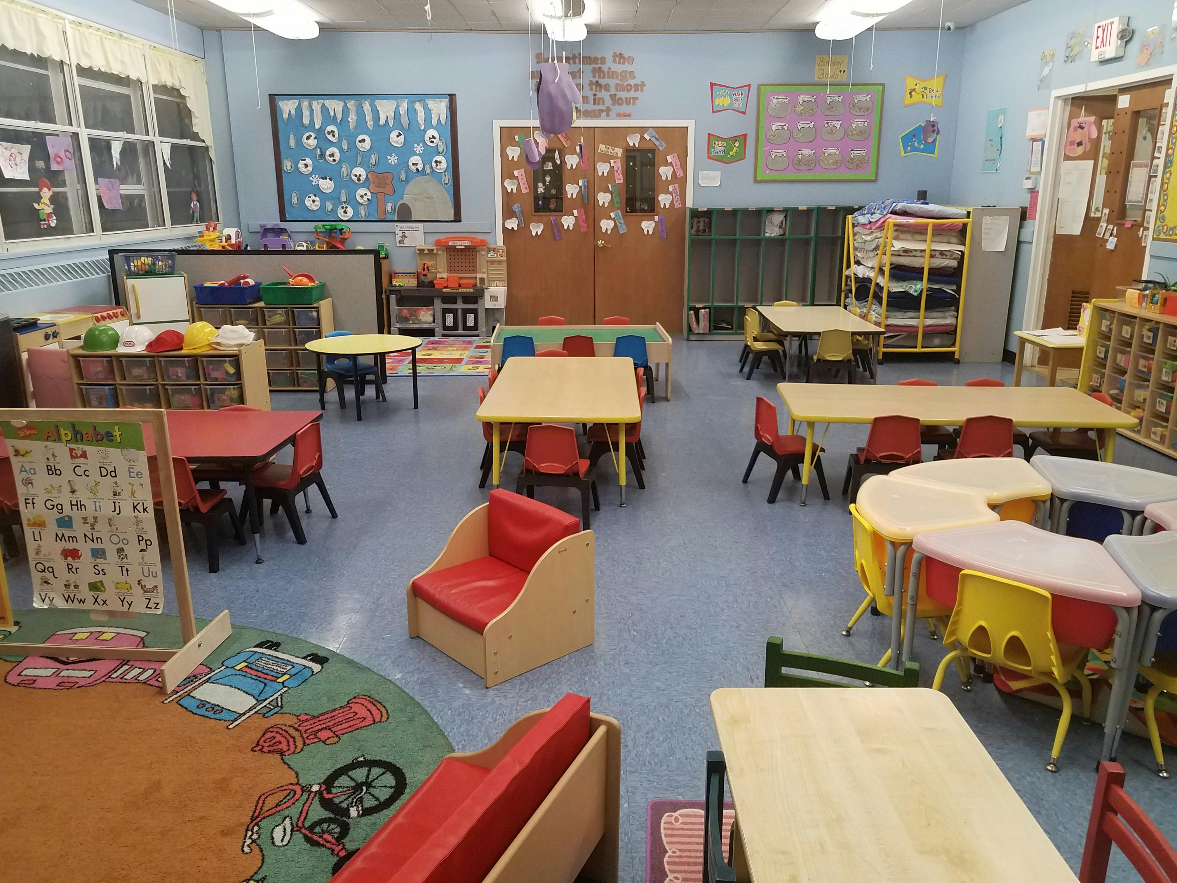 Empty classroom with small tables and chairs