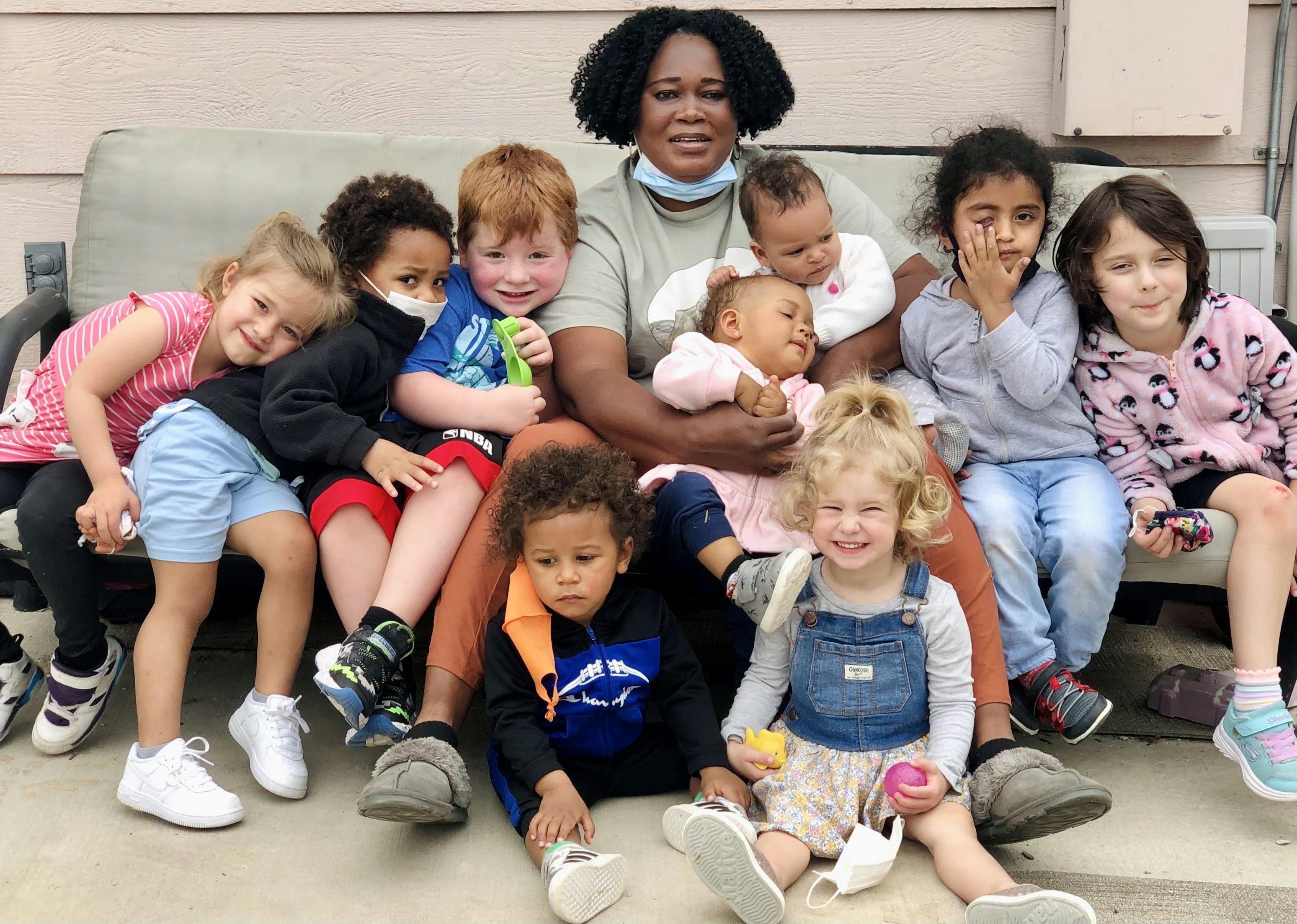Adult person sitting with multiple children and babies
