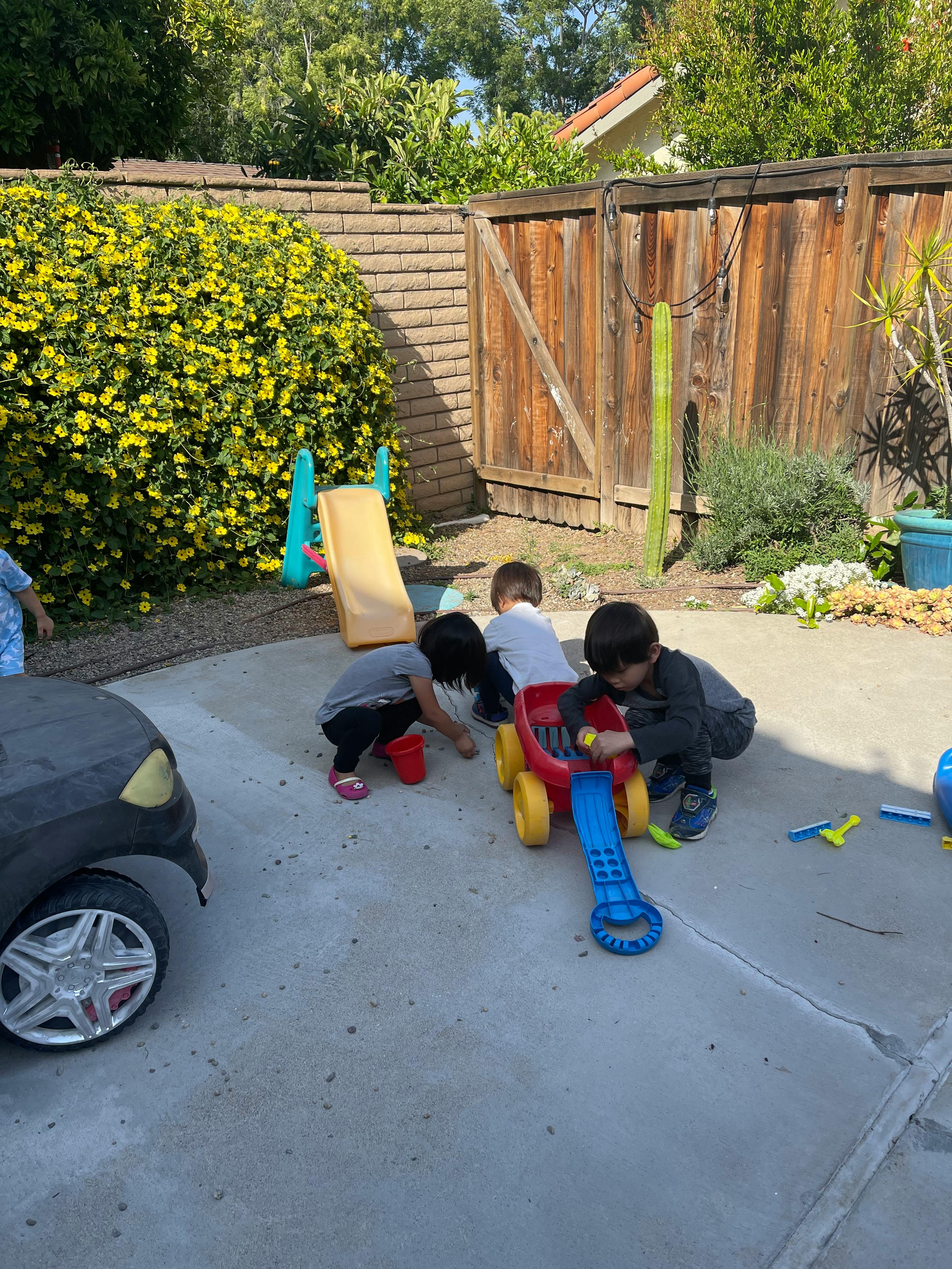 Children playing with toys on a patio