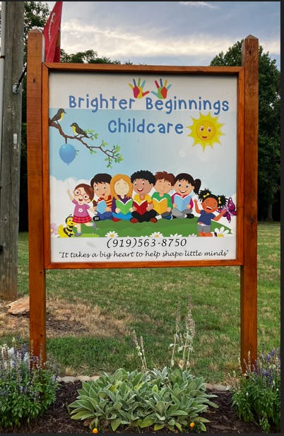 Brighter Beginnings Childcare sign with illustrated children reading