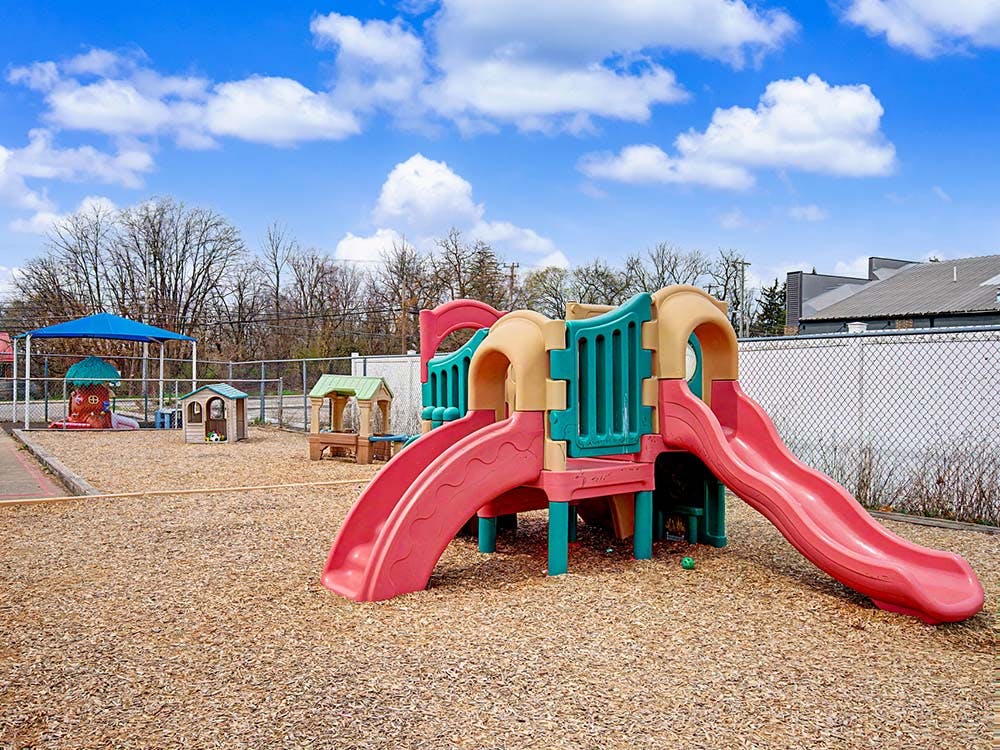 Playground with slides, playhouses, and wood chip ground