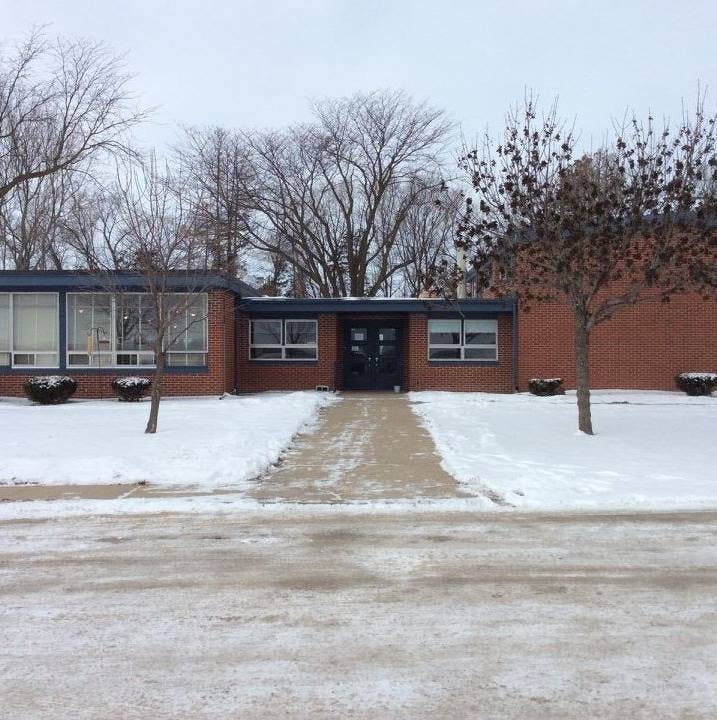 Building with a path leading to the entrance, surrounded by snow