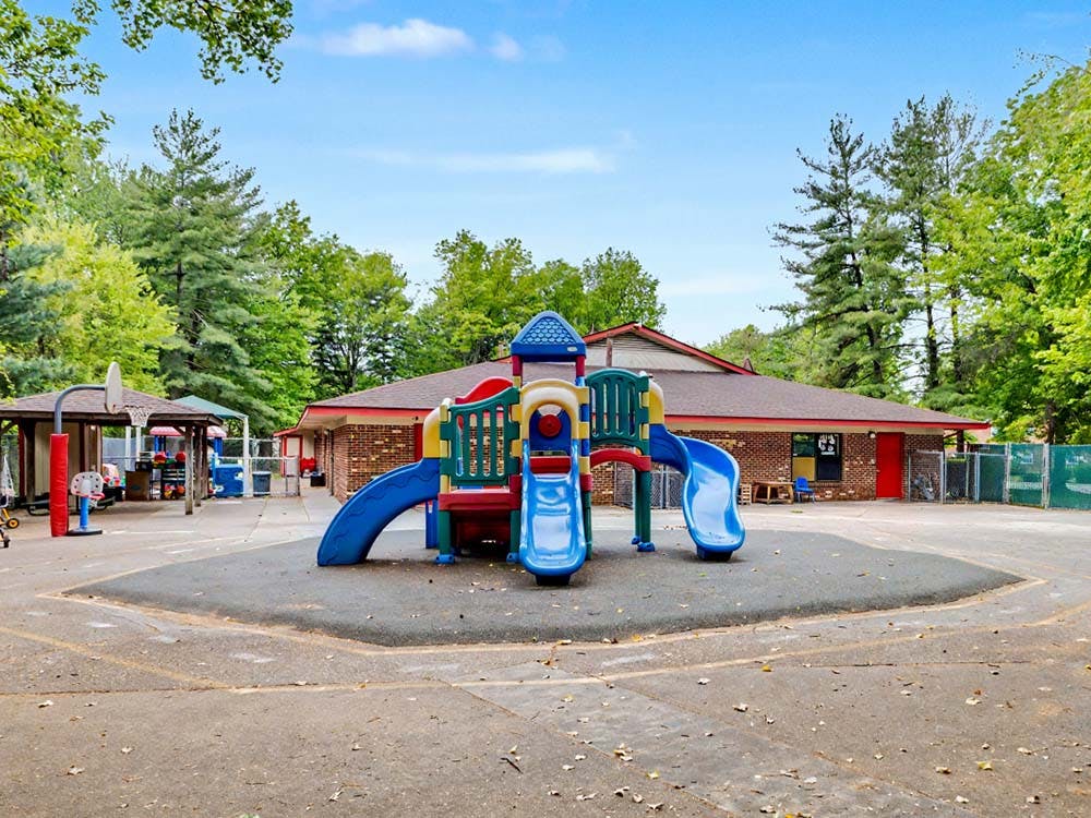 Colorful outdoor playground structure with slides and a climbing area