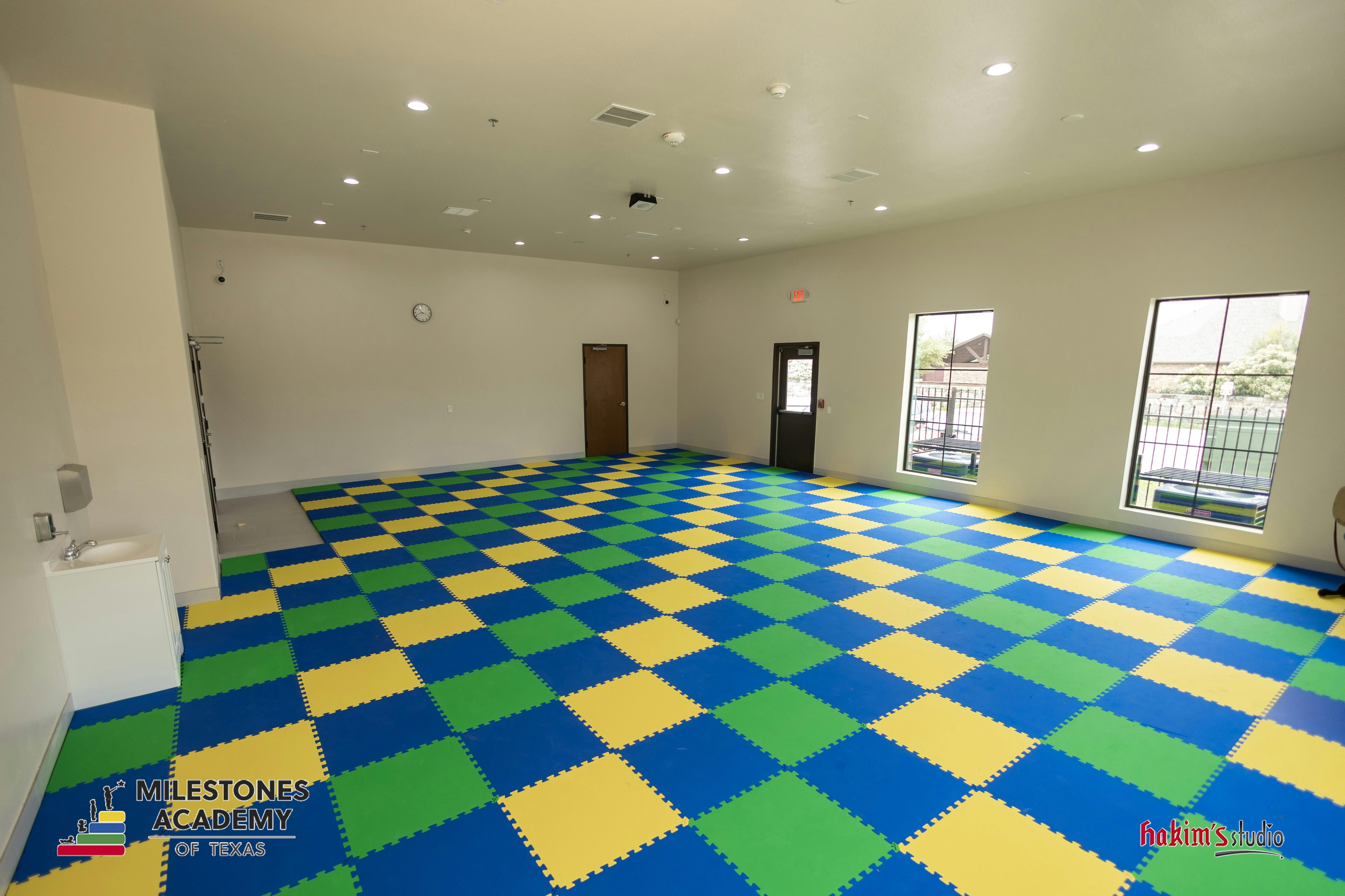 empty room with checkerboard floor and two windows