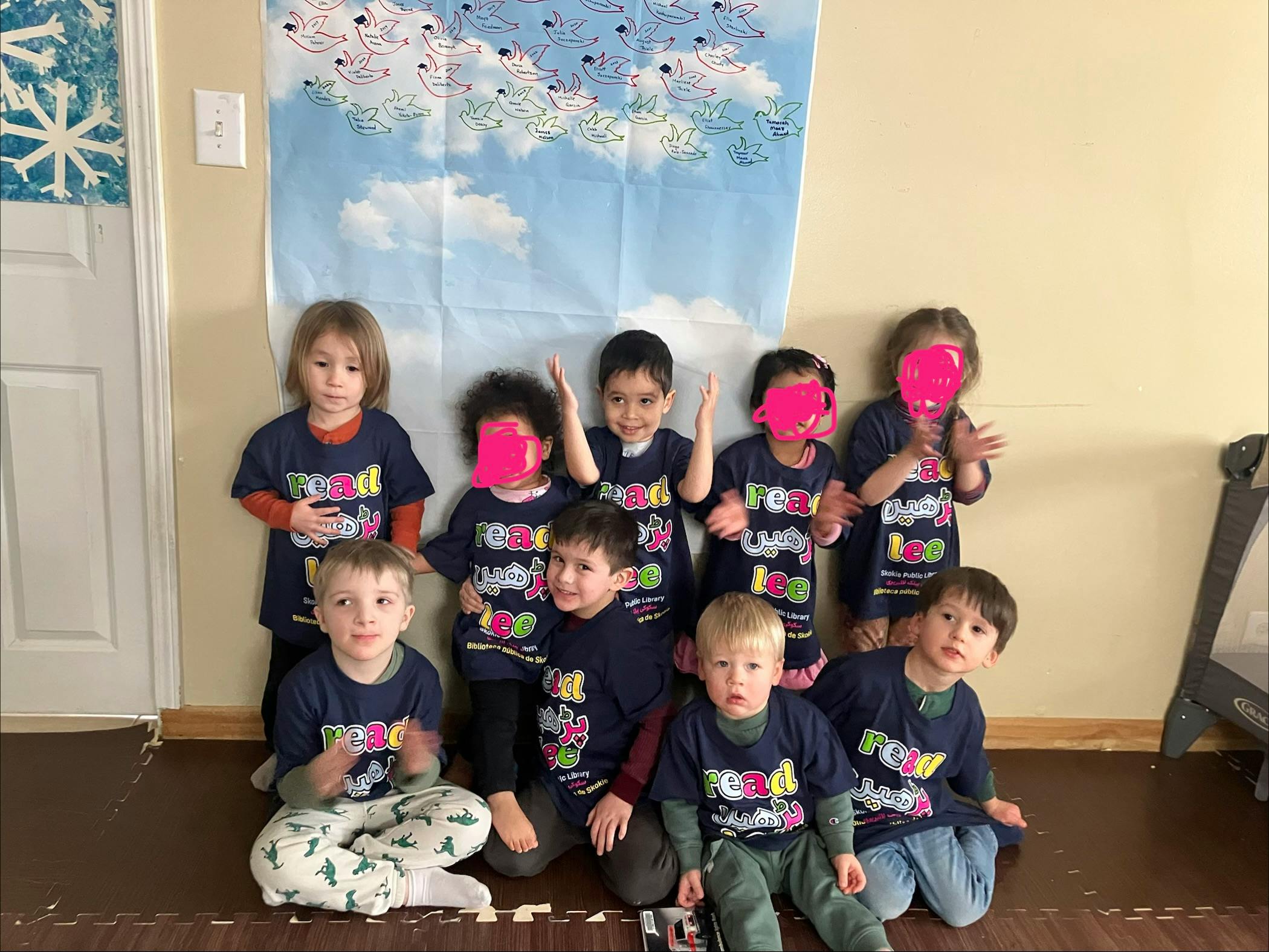 Group of children wearing blue t-shirts with “read” and “Lee” text