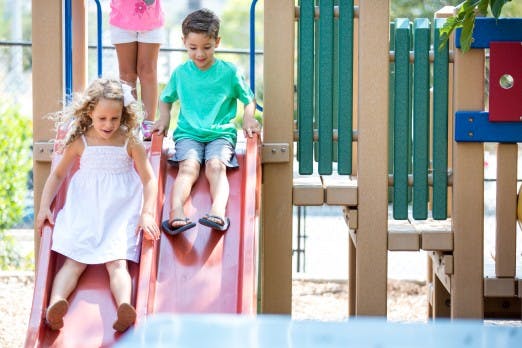 Two children on a playground slide