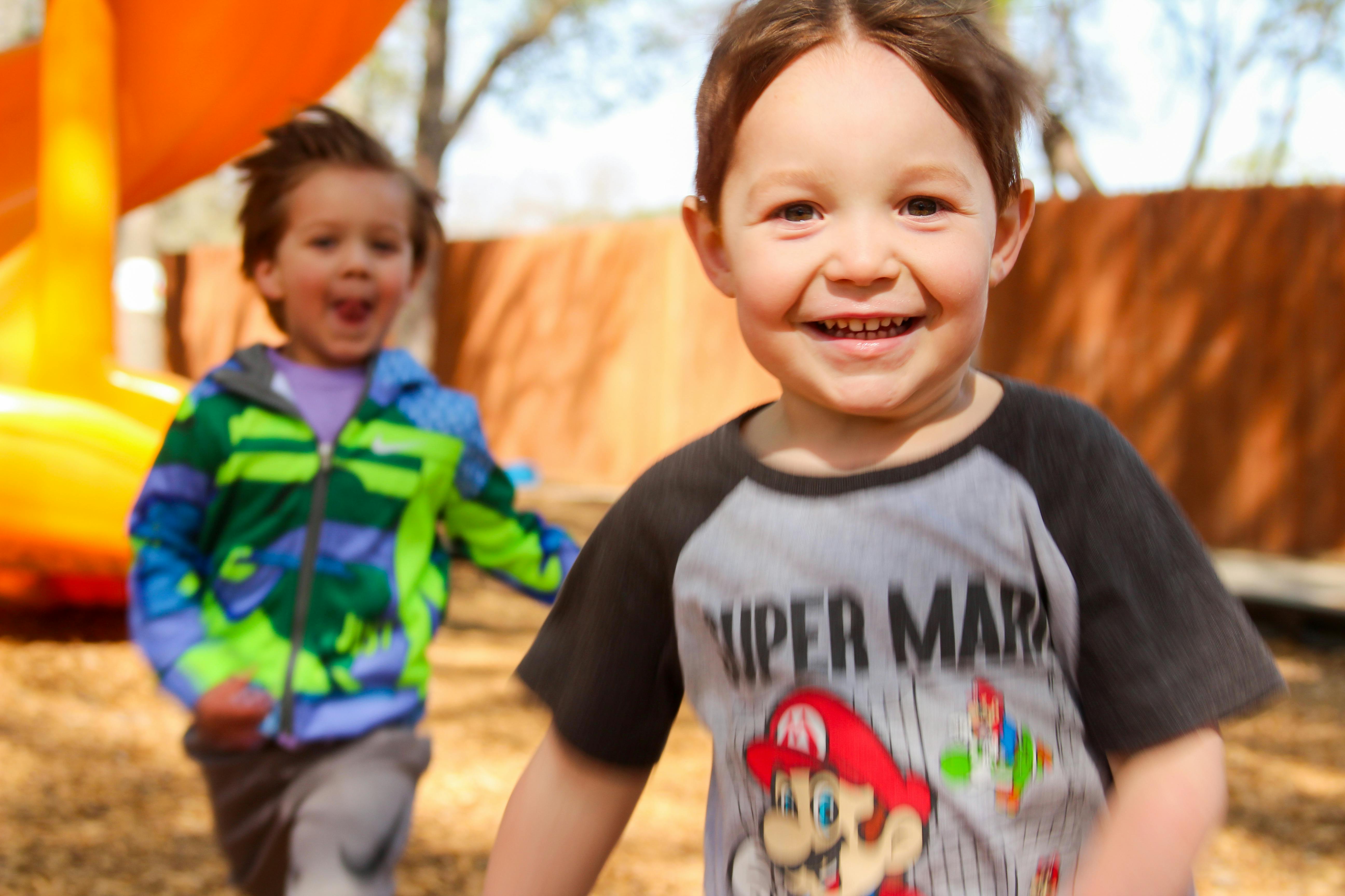 Two children running outdoors