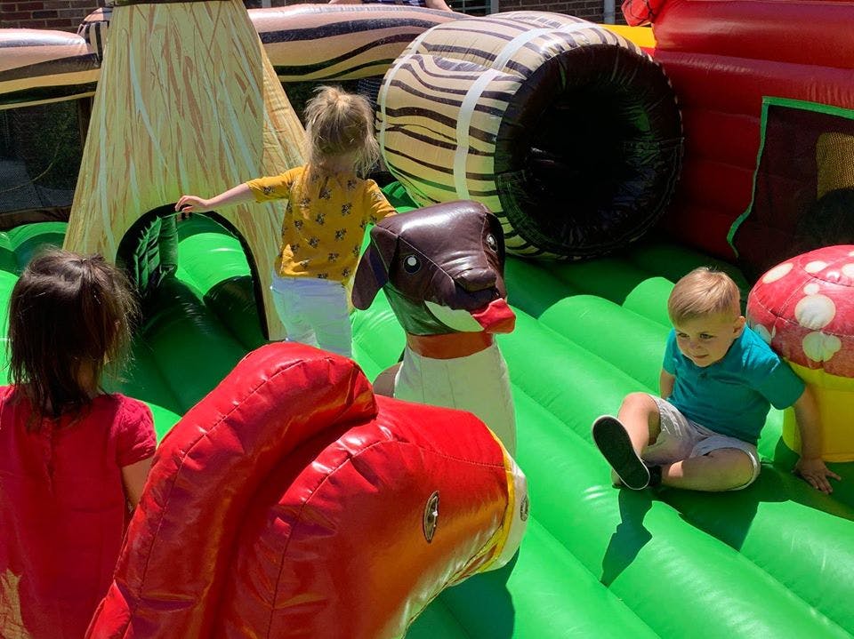 Children playing on an inflatable bounce house