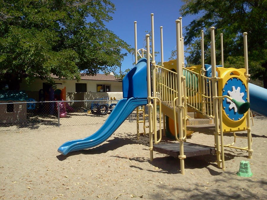 Playground with blue slide and yellow climbing structure