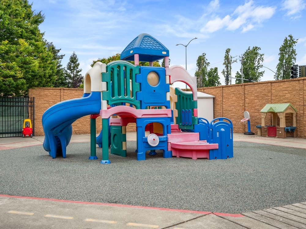 Colorful plastic playground structure on soft ground