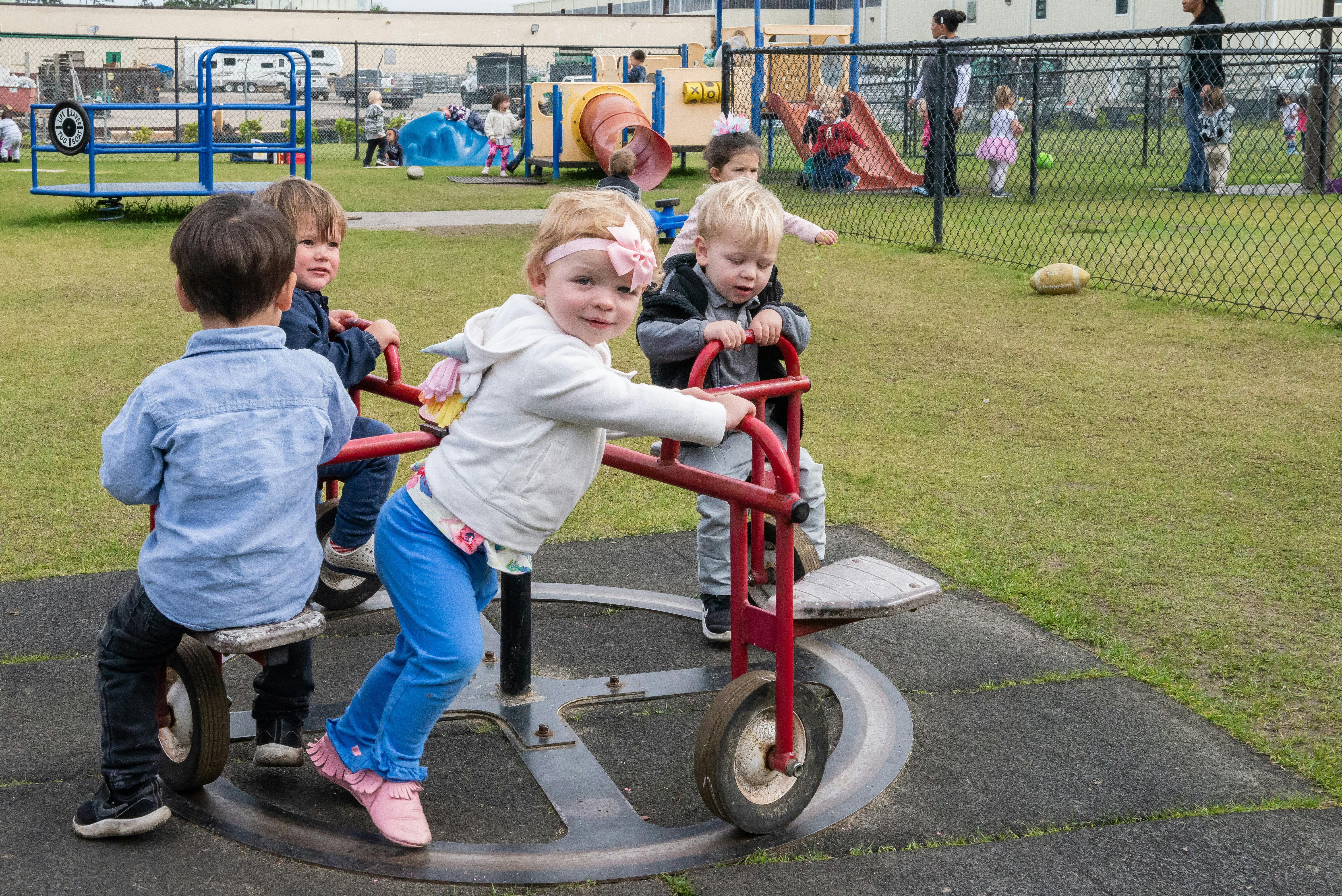 Children playing on a spinning playground ride