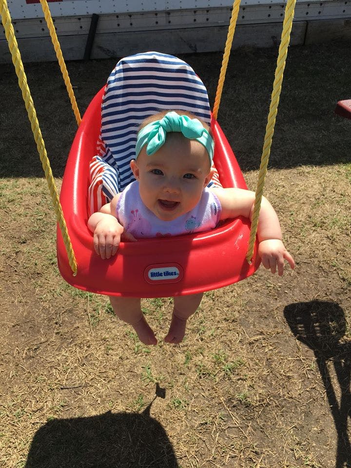 Child in a red swing