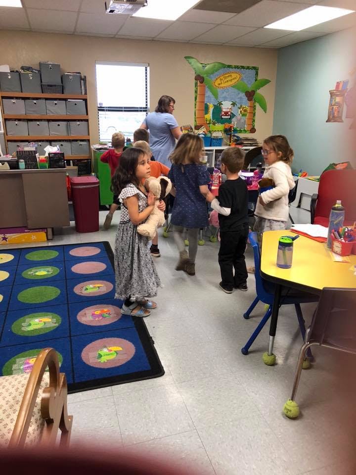 Children and an adult in a classroom