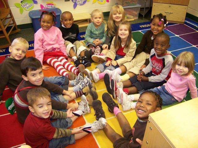 Group of children sitting on a colorful rug