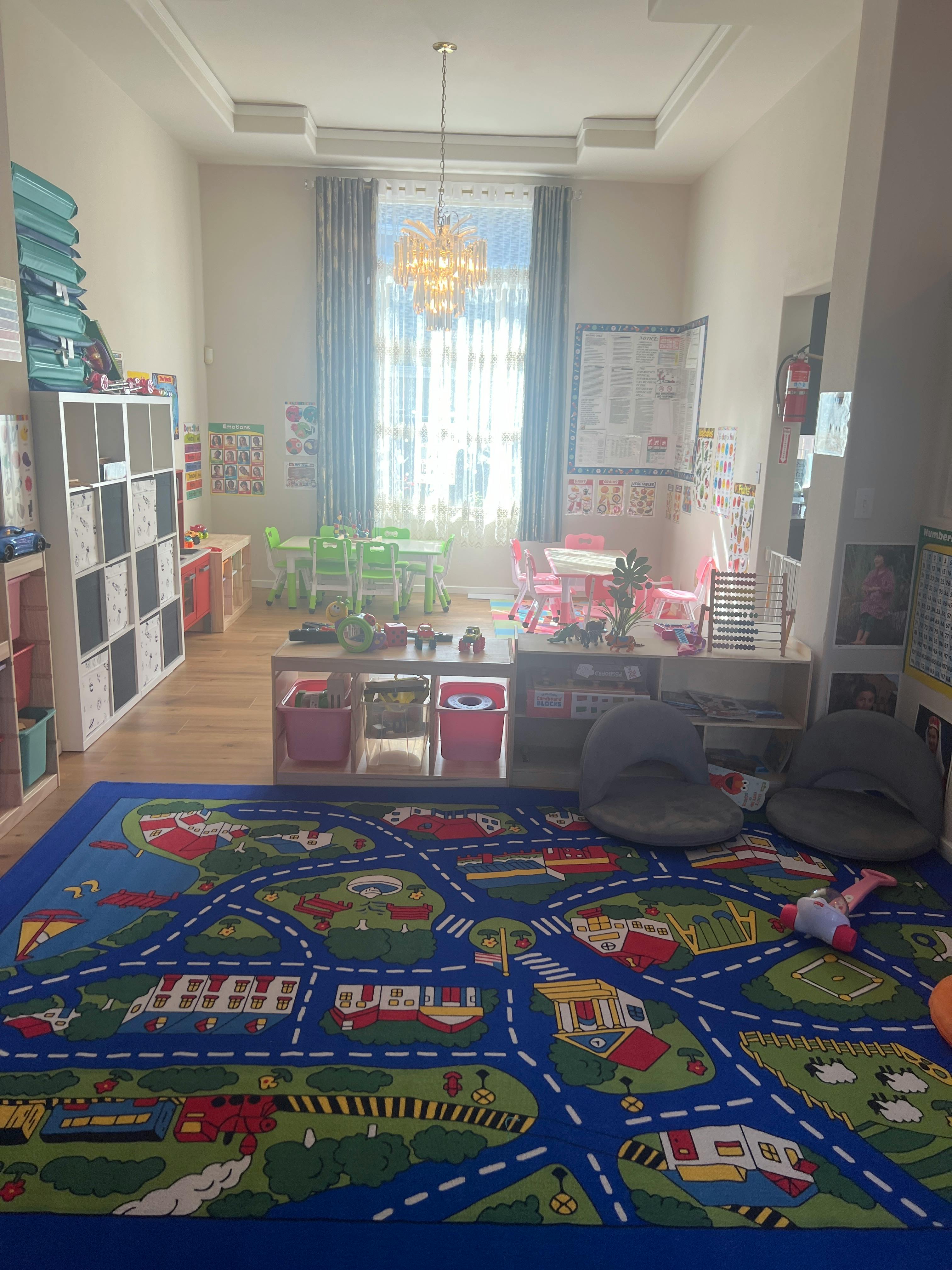 Playroom with a road map rug, small tables, and chairs