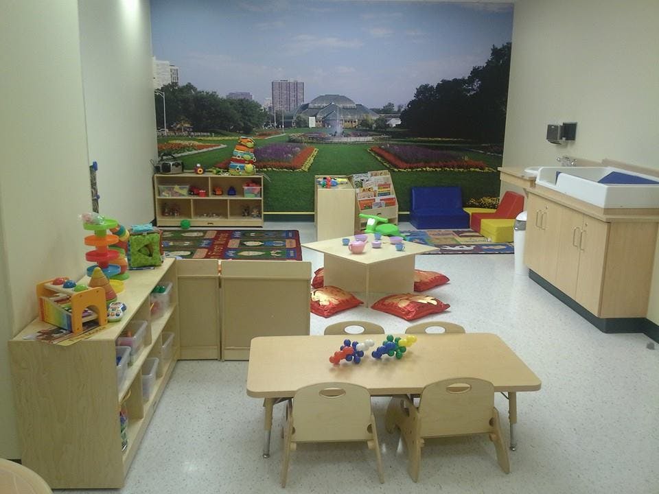 Playroom with small tables, chairs, and toys